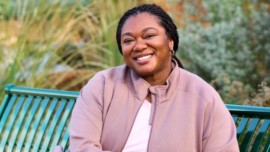 woman sitting on a bench, smiling