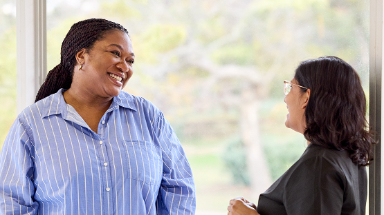Patient and provider having a conversation in front of window.