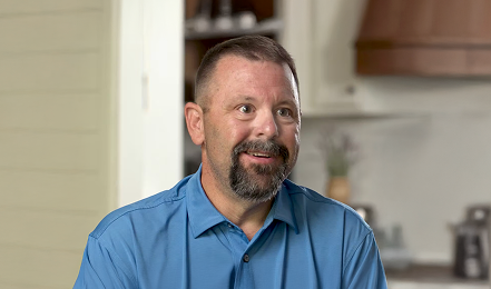 Man smiling during interview.