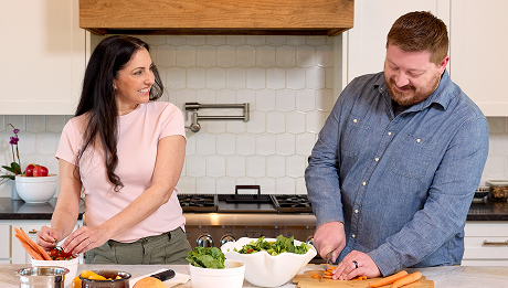 Couple cooking together in a kitchen.