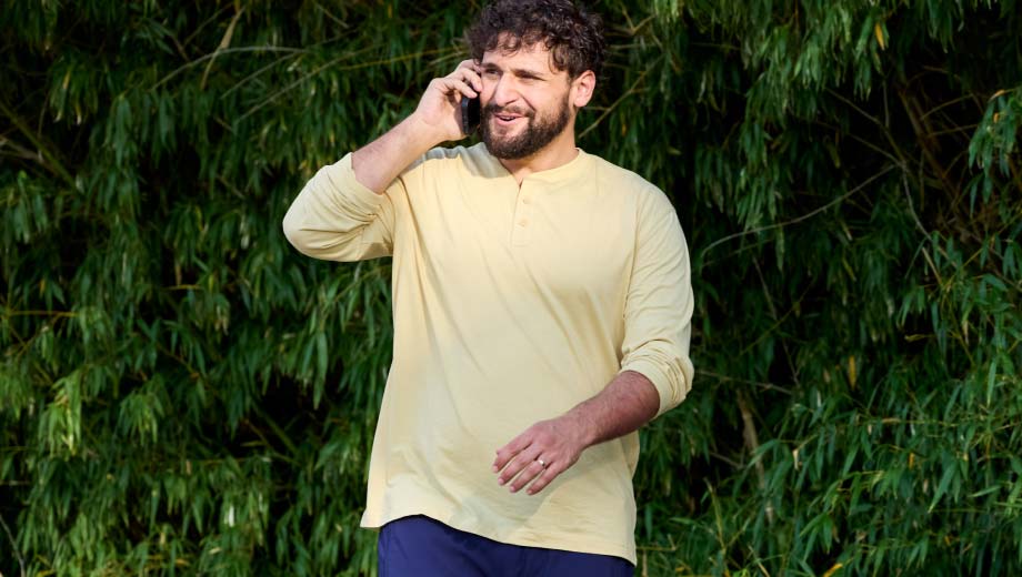 Man outside talking on phone.